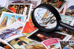 Stamp collection with magnifying glass, shallow depth of field